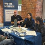 Forbo Flooring Systems staff speaking with a jobseeker at a recruitment stand.